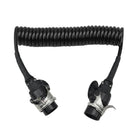 Black coiled truck trailer electrical cable with two connectors on a white background