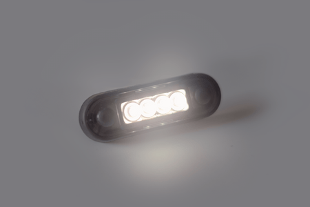 LED oval marker light glowing on a plain gray background